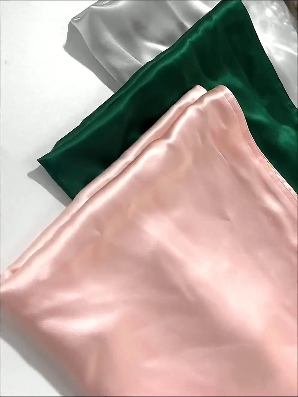 Real pink and deep green silk pillowcase samples shown together